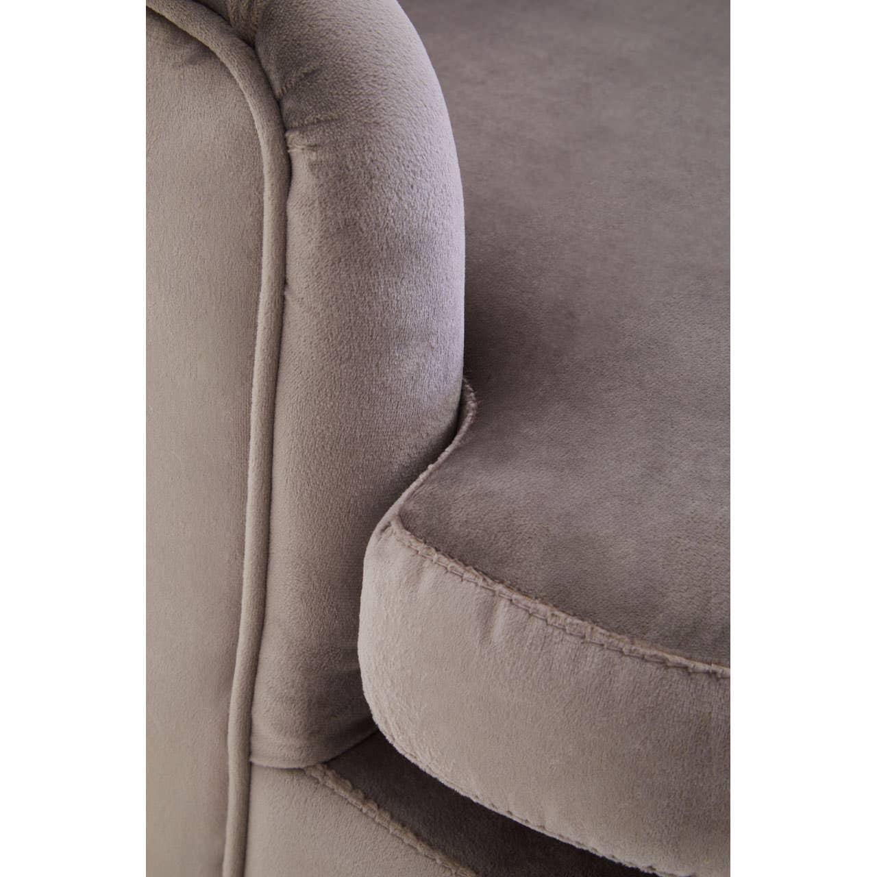 Close-up of grey fabric sofa armrest and seat cushion showing soft upholstery texture