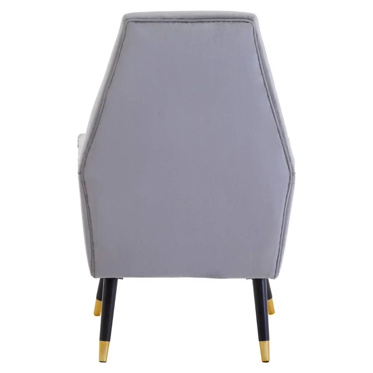 Rear view of grey upholstered accent chair with black legs and gold tips