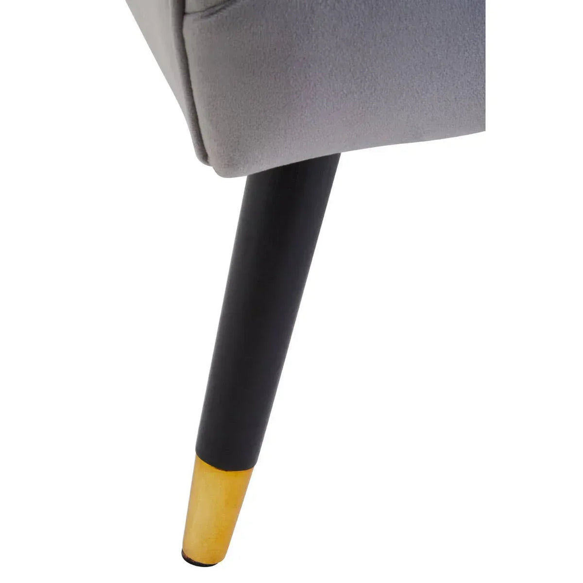 Close-up of sofa leg with black and wood finish under grey upholstered seat