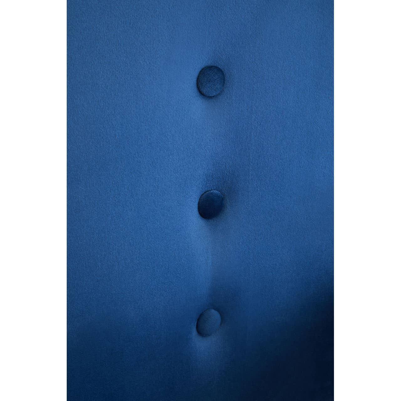 Blue velvet sofa upholstery with button tufted detailing in close-up view