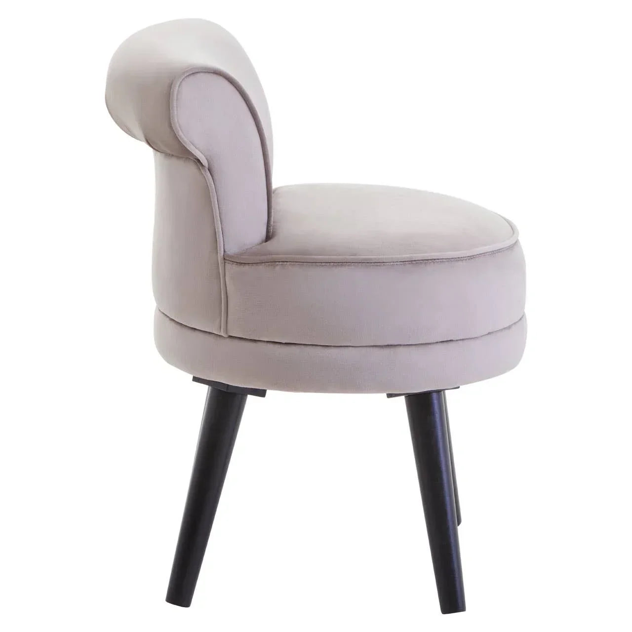 Beige velvet accent chair with curved backrest and black tapered legs, side view