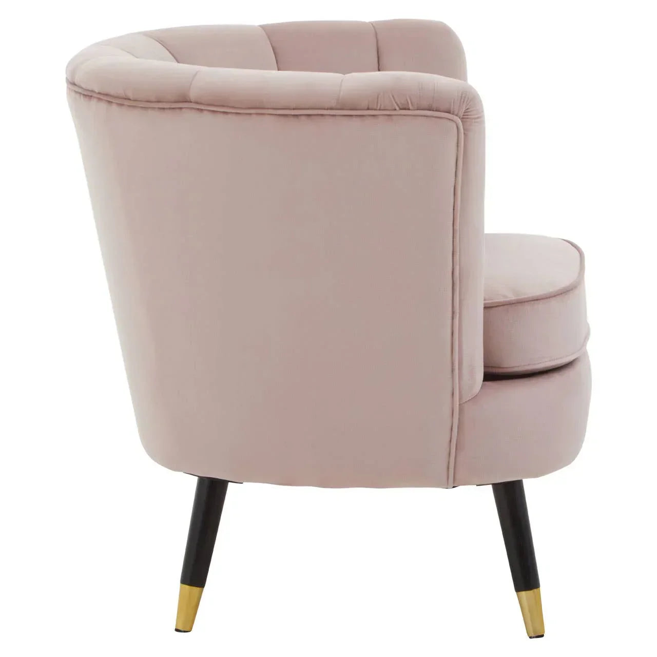 Blush pink velvet accent chair with gold-tipped black legs, rear angled view
