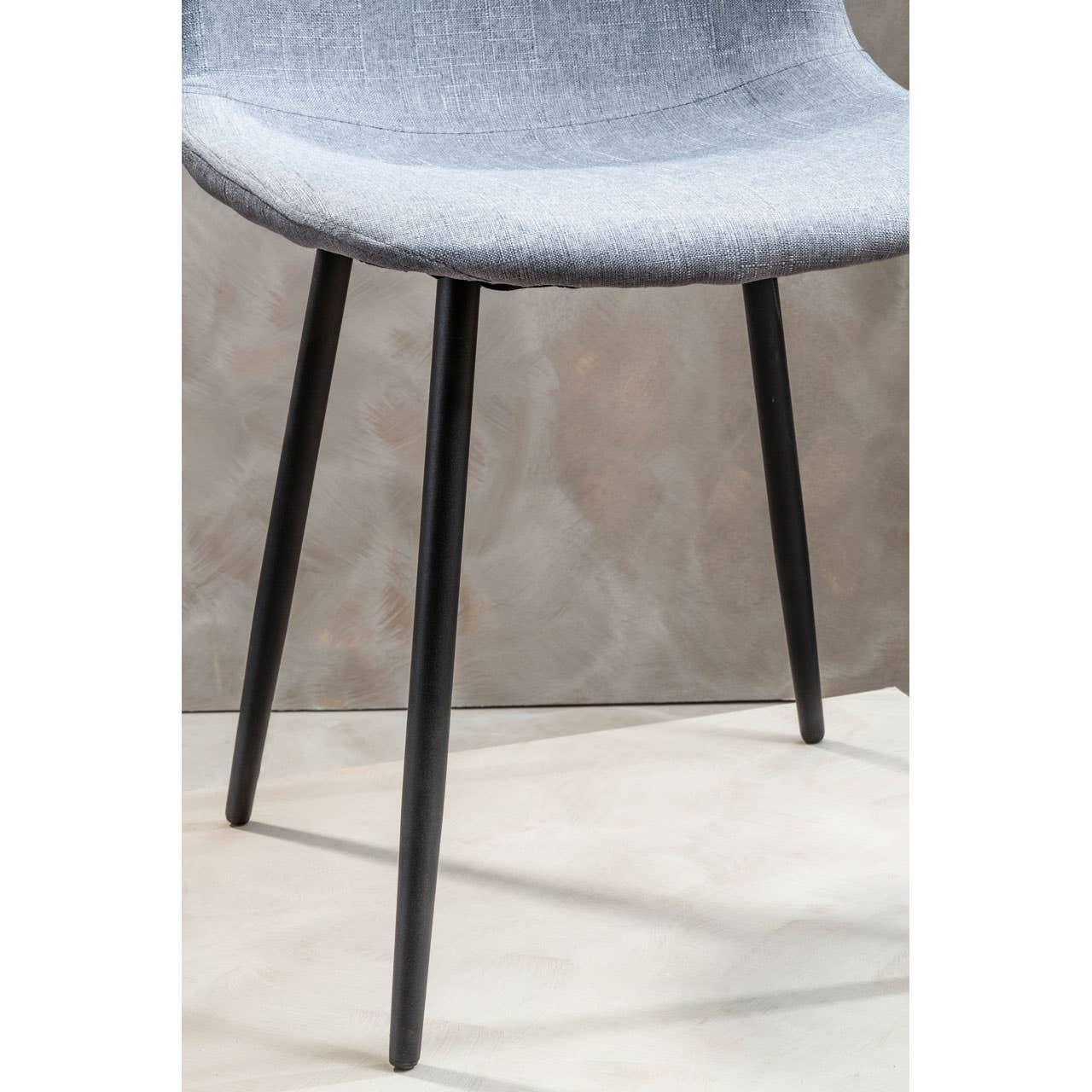 Light grey fabric dining chair with black metal legs, shown from side angle