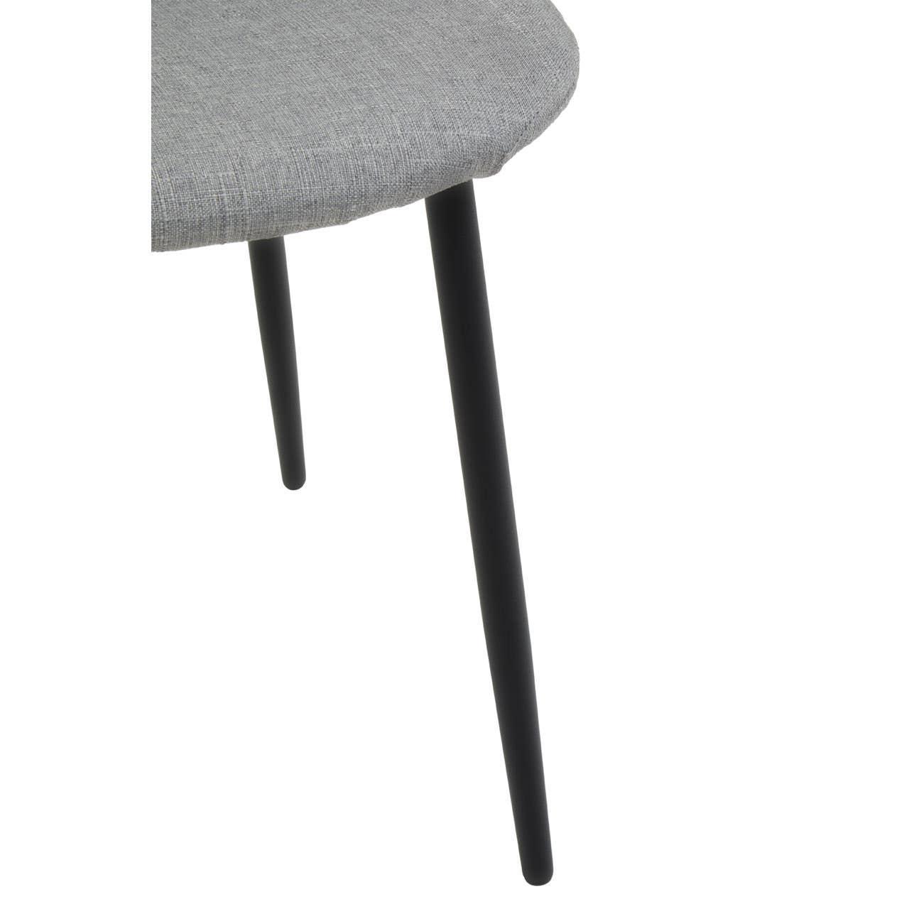 Detail view of grey fabric dining chair seat with black metal legs