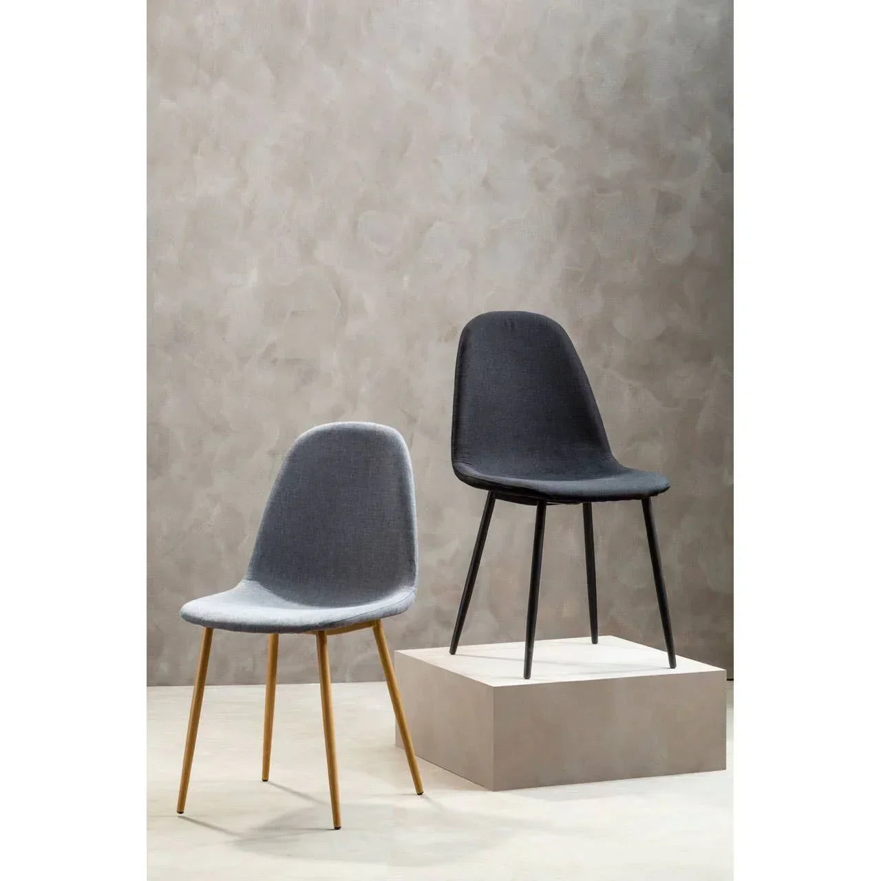 Set of two modern dining chairs, one grey with wooden legs, one dark grey with black legs