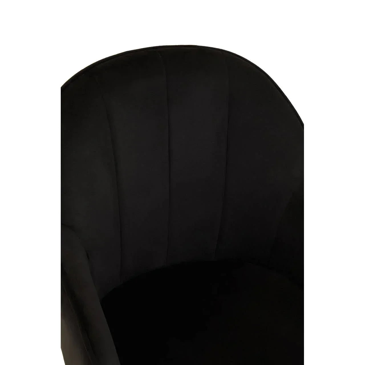 Black velvet accent chair curved backrest close-up