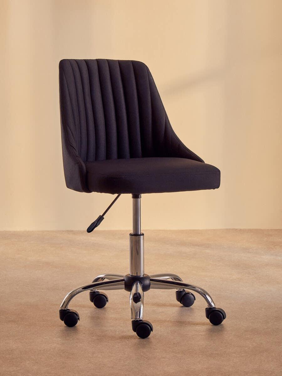 Black swivel office chair with vertical stitching and chrome base on castor wheels