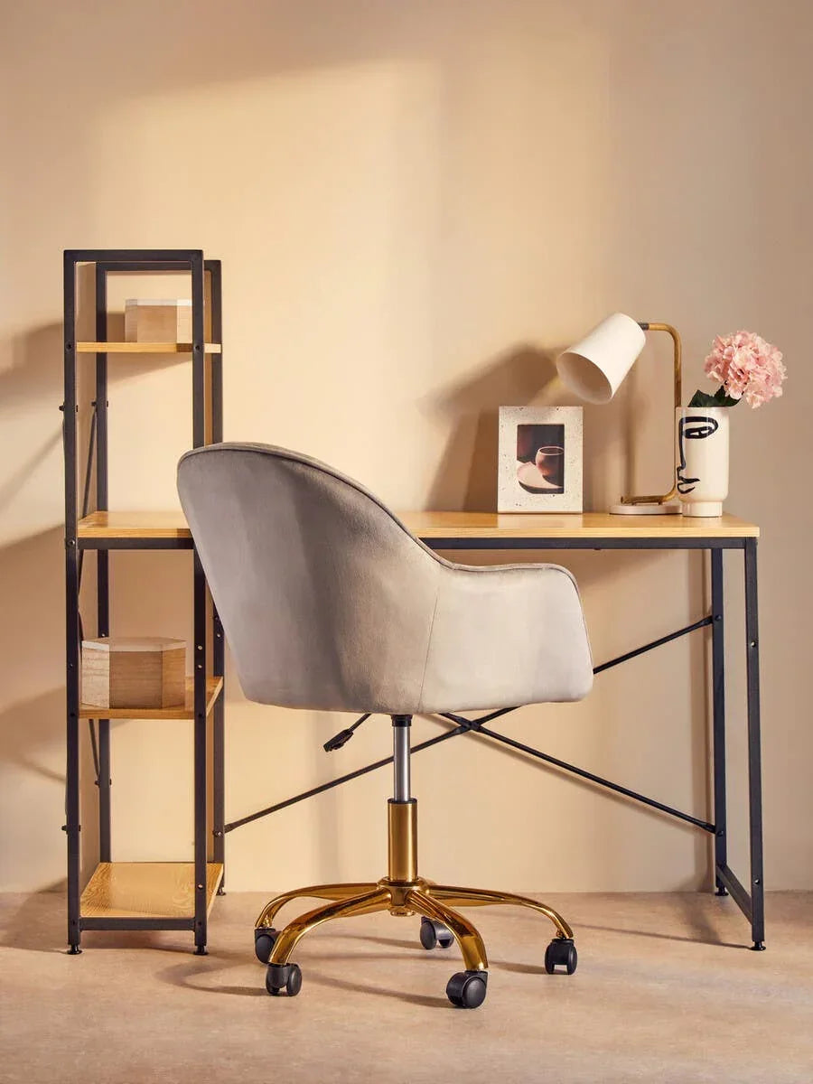 Modern desk with shelving, taupe swivel office chair and lamp in home office setup