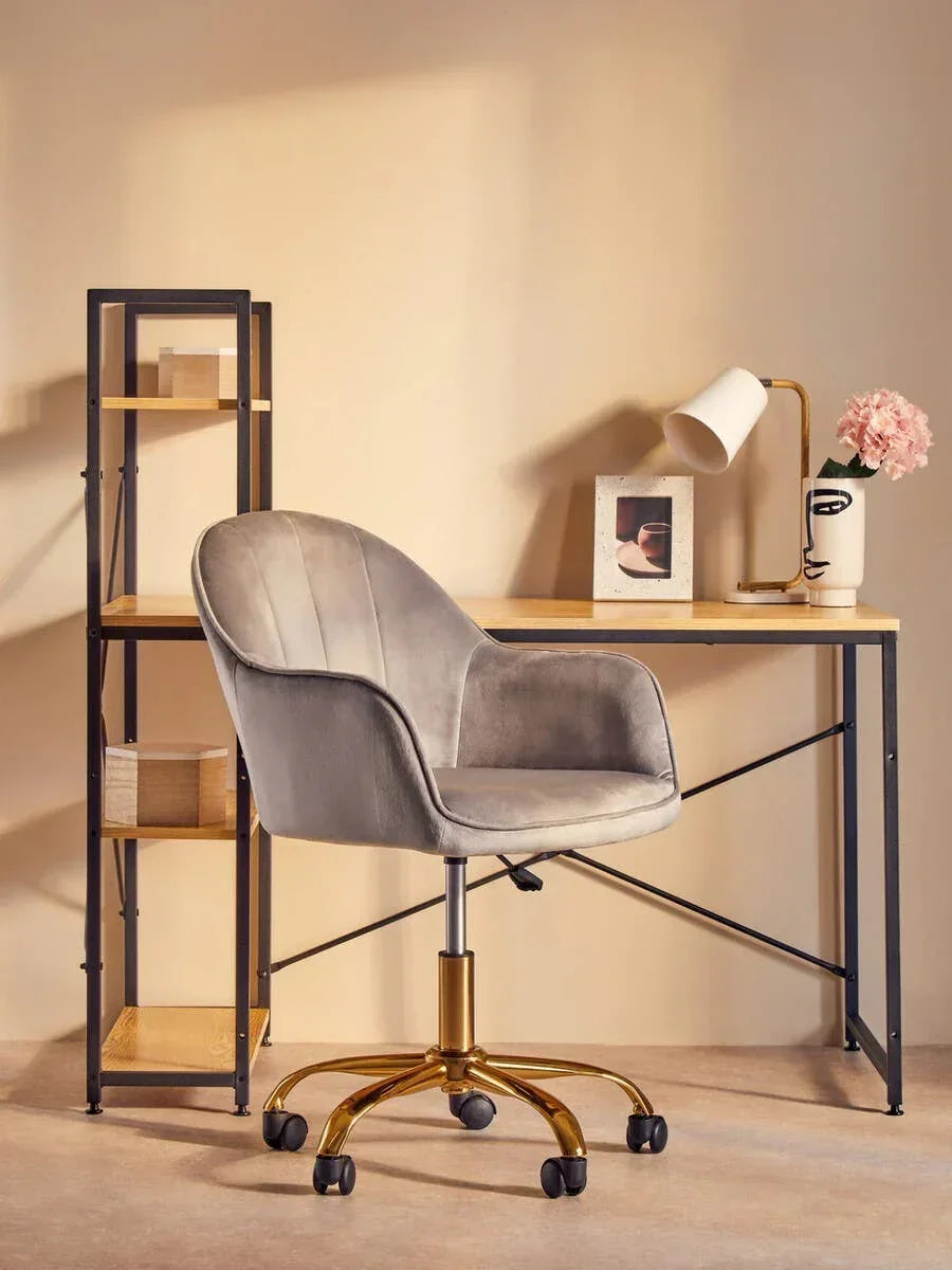 Velvet office chair with gold base and modern desk in minimalist home workspace