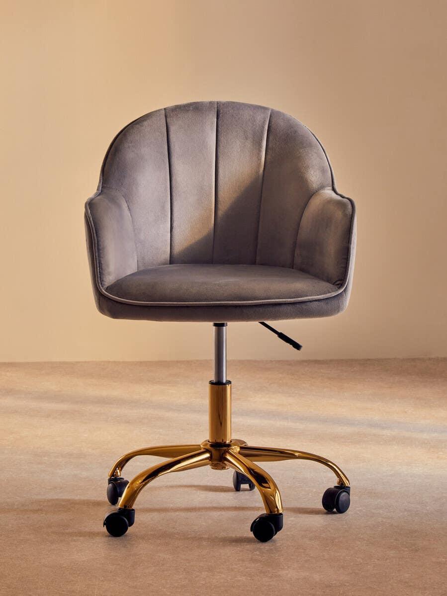 Grey velvet office chair with gold metal base and swivel casters, front view