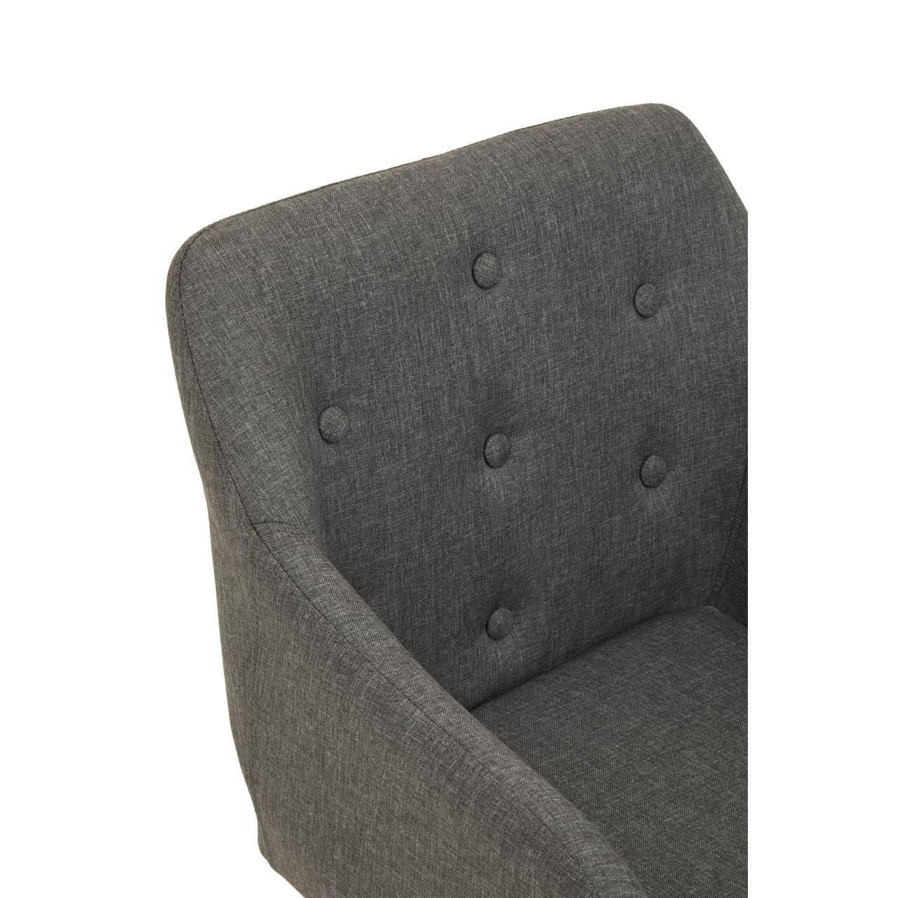 Dark grey fabric armchair with button-tufted backrest, close-up of seat and arm detail