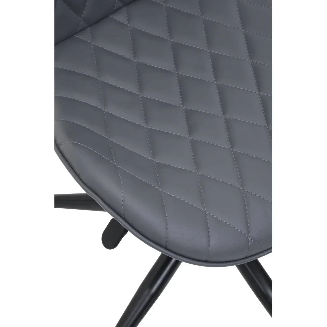 Close-up of grey dining chair with quilted faux leather seat and black metal legs