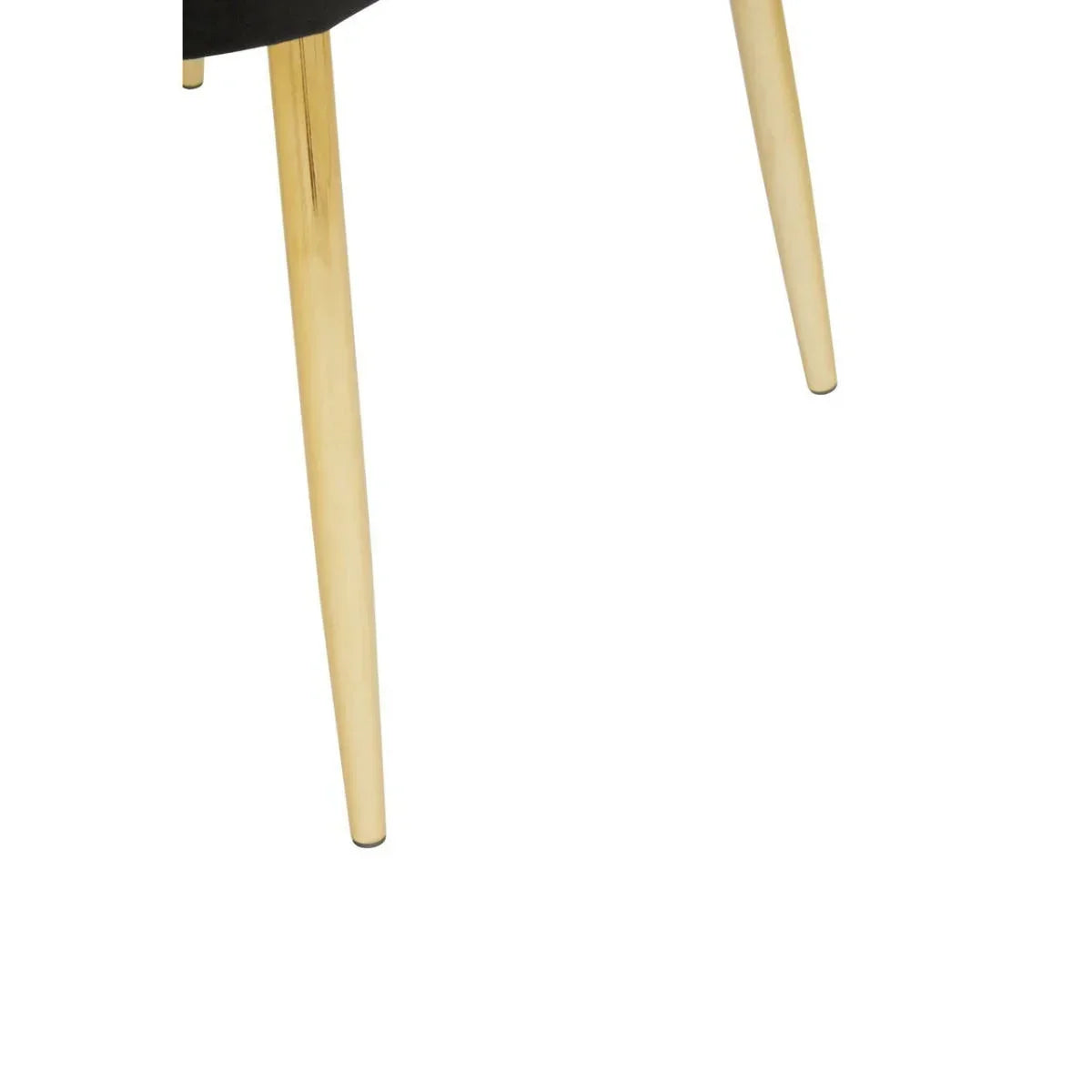 Close-up of gold metal chair legs with black seat, modern dining chair detail