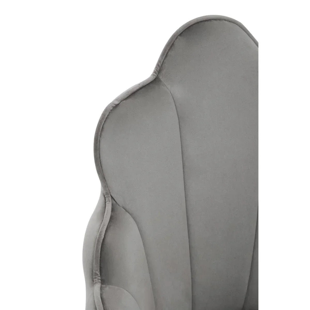 Close-up of grey velvet accent chair scalloped backrest