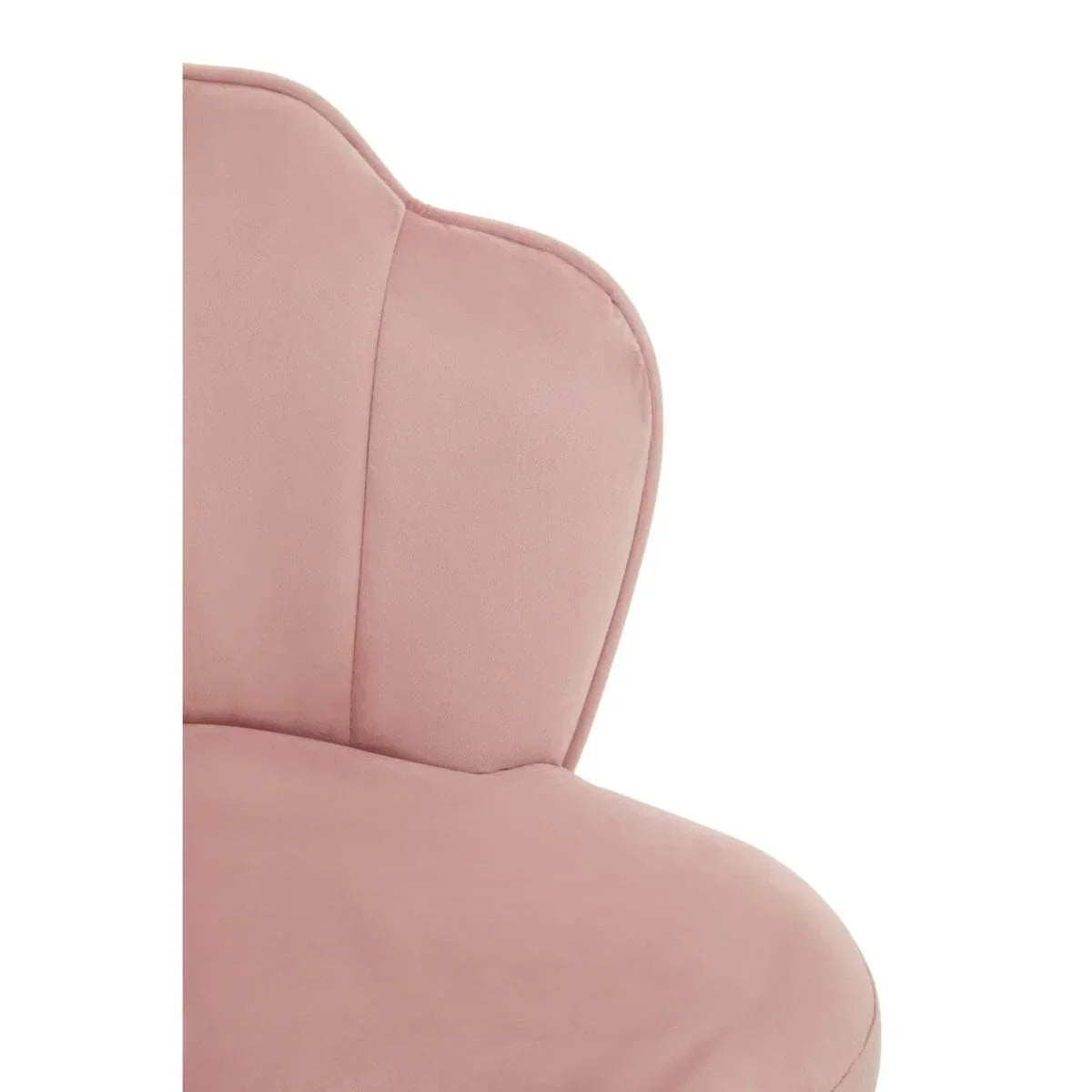 Close up of pink velvet accent chair with curved backrest and stitched detail