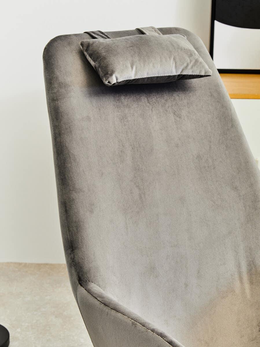 Grey velvet lounge chair with adjustable headrest in modern room setting