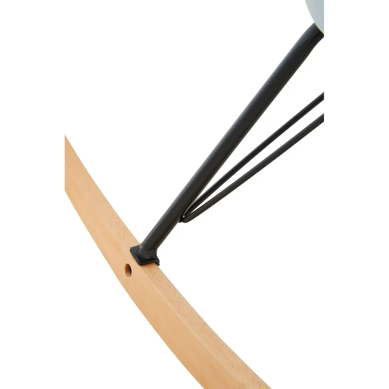Close-up of wooden rocking chair base with black metal support legs
