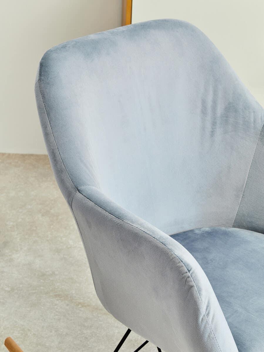 Light grey velvet dining chair with curved backrest and black metal legs
