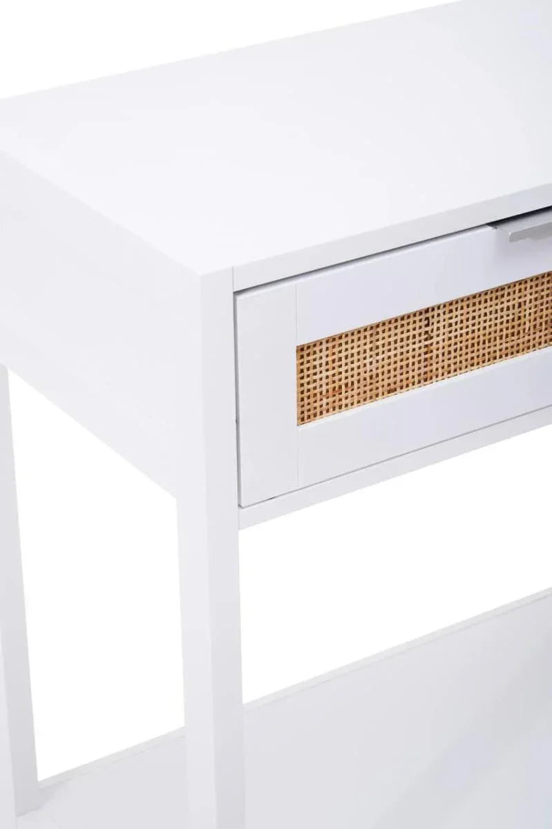 White console table with single drawer and rattan panel detail, side angle view