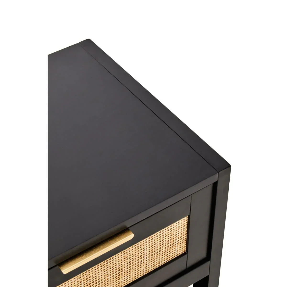 Black bedside table with rattan drawer front and brass handle, corner close-up view