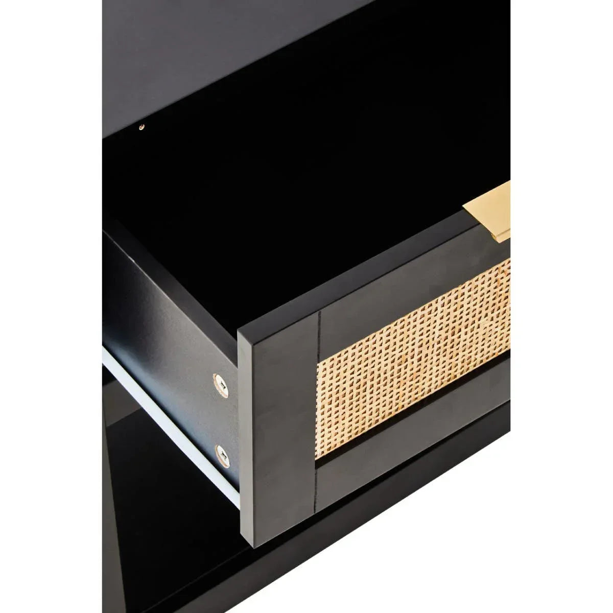 Black wood drawer with rattan front panel and gold metal handle, closeup view