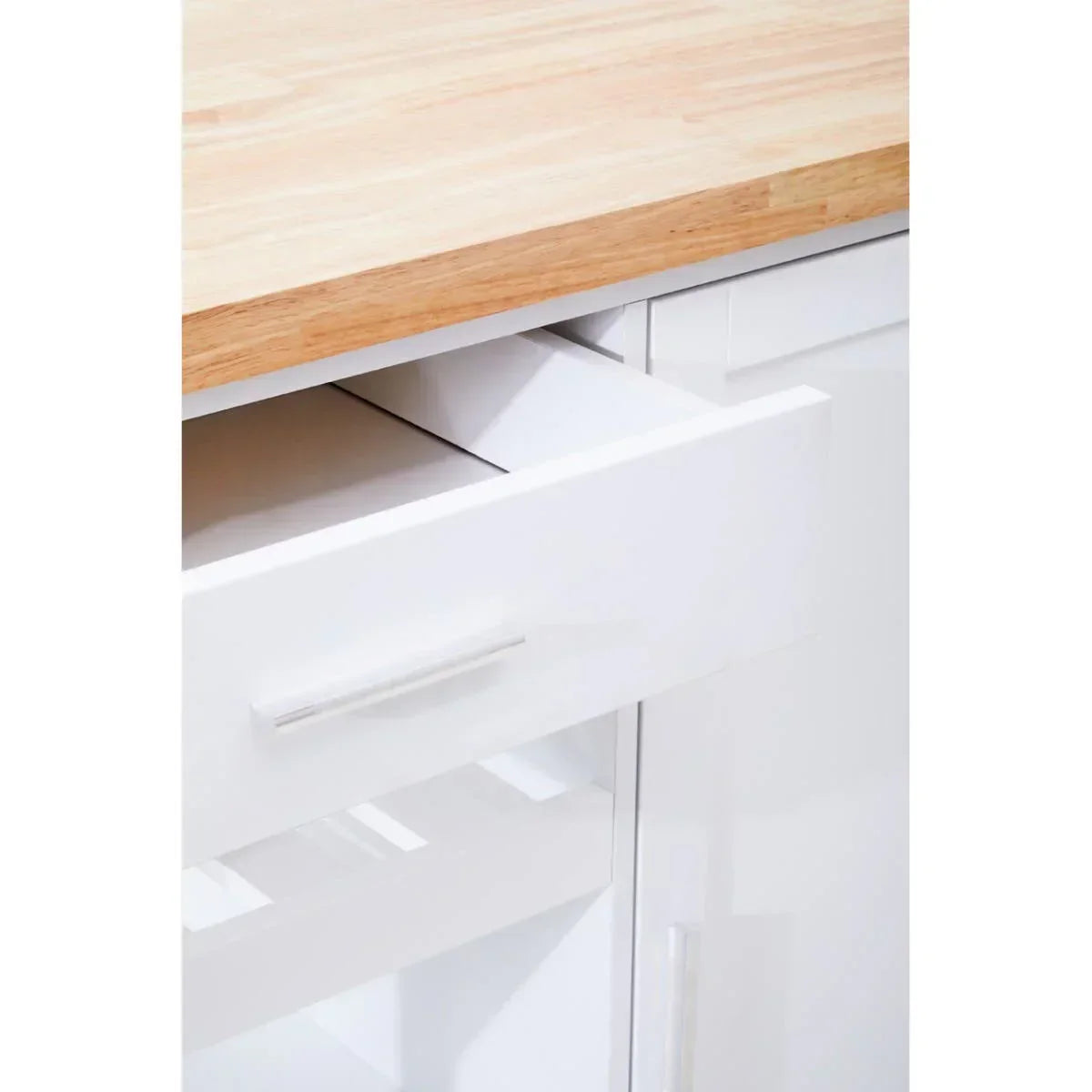 White kitchen cabinet with open drawer and wood countertop closeup