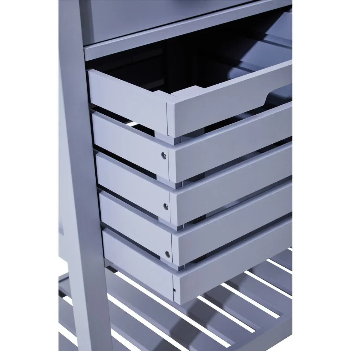 Closeup of grey wooden storage unit with open slatted drawer and shelf