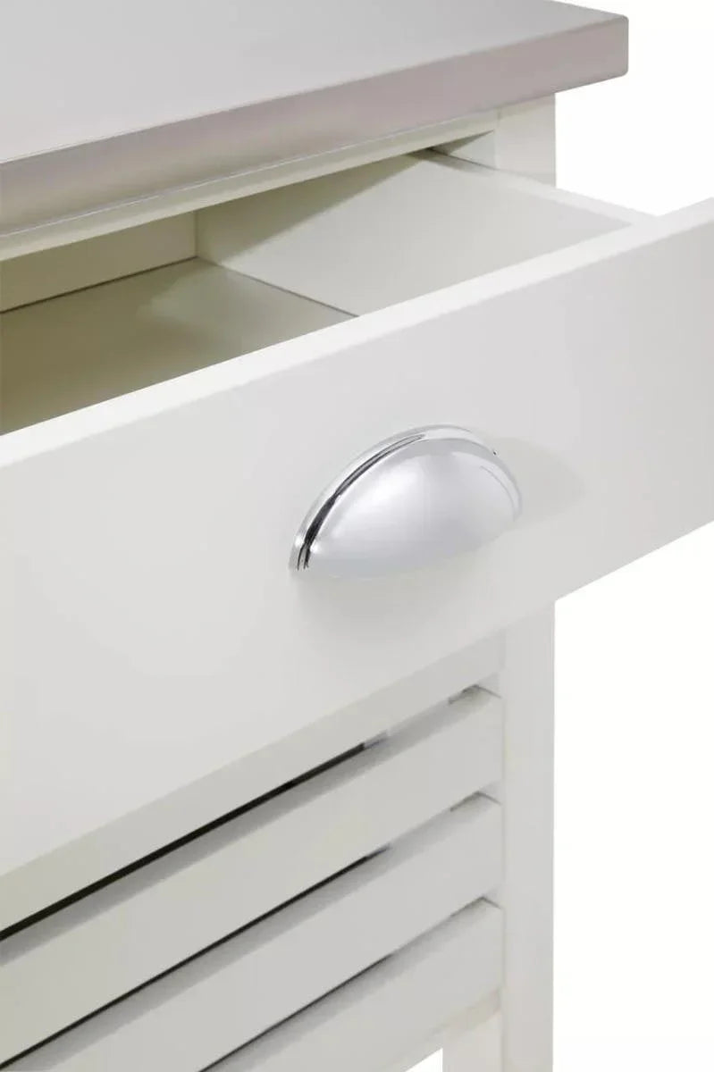 White wooden drawer with metal handle and stainless steel top, close-up angle