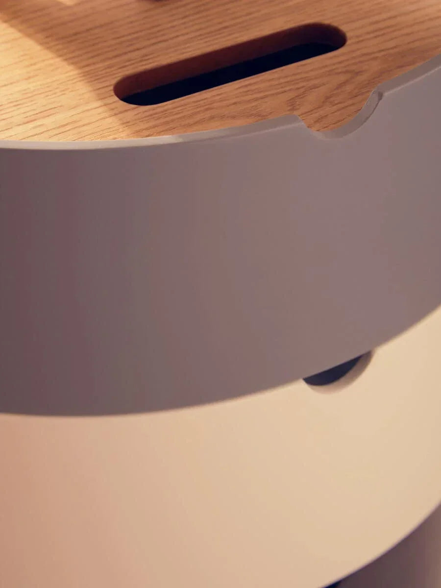Close-up of wooden top storage drawer with white and beige rounded drawer fronts