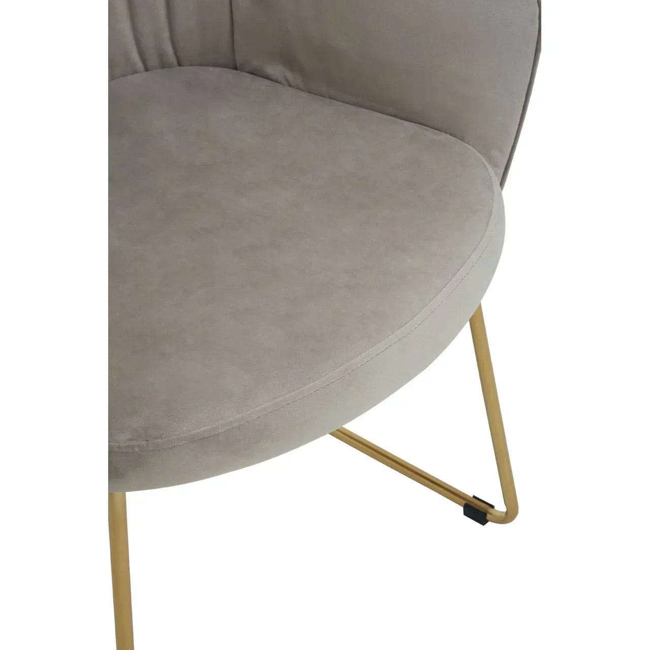 Beige accent chair seat with curved backrest and gold metal legs, close-up view