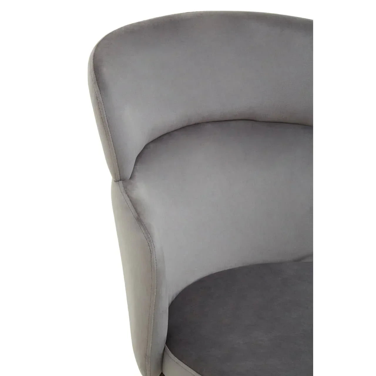 Close-up of grey velvet armchair with curved backrest and seat cushion