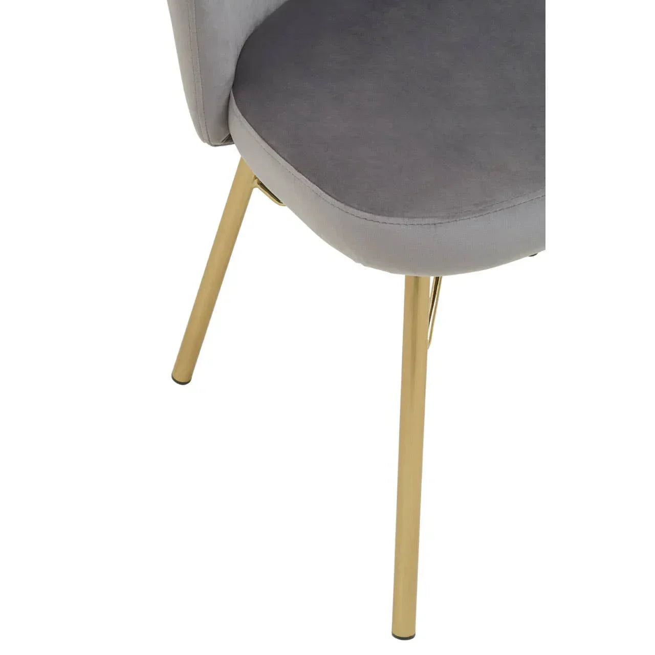 Grey velvet dining chair with gold metal legs, close-up of seat and lower frame