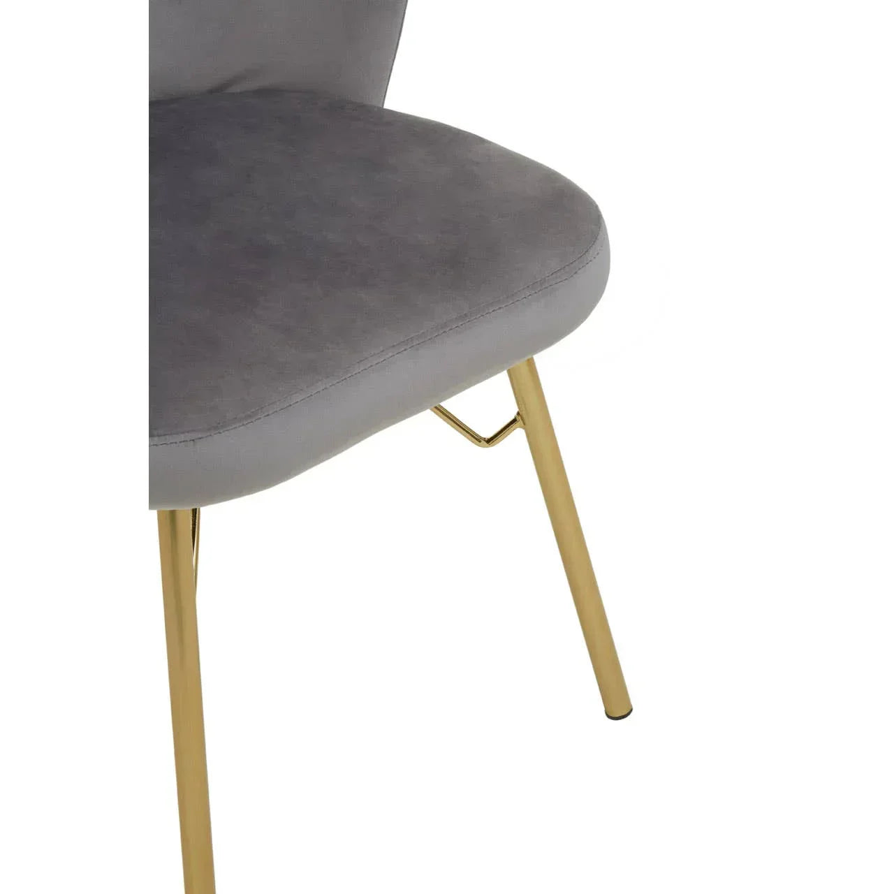 Grey upholstered dining chair with gold metal legs, close-up of seat and leg detail