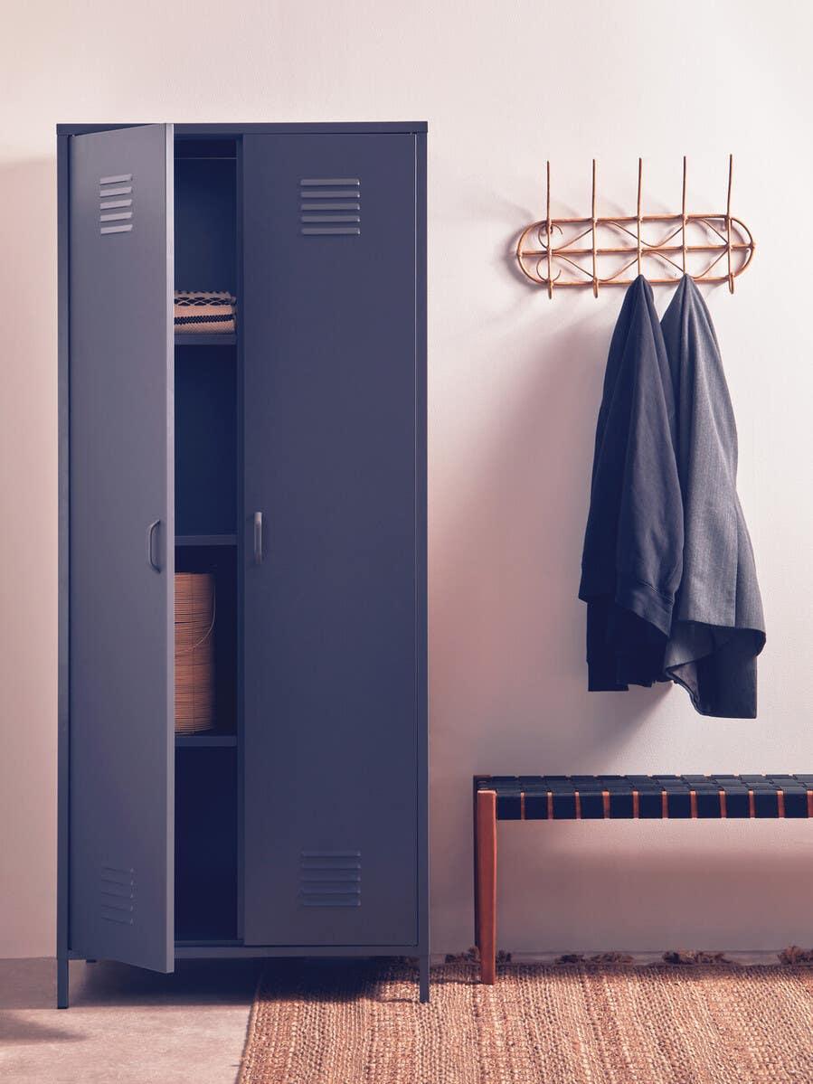 Dark blue metal storage cabinet with partially open doors in modern hallway setting