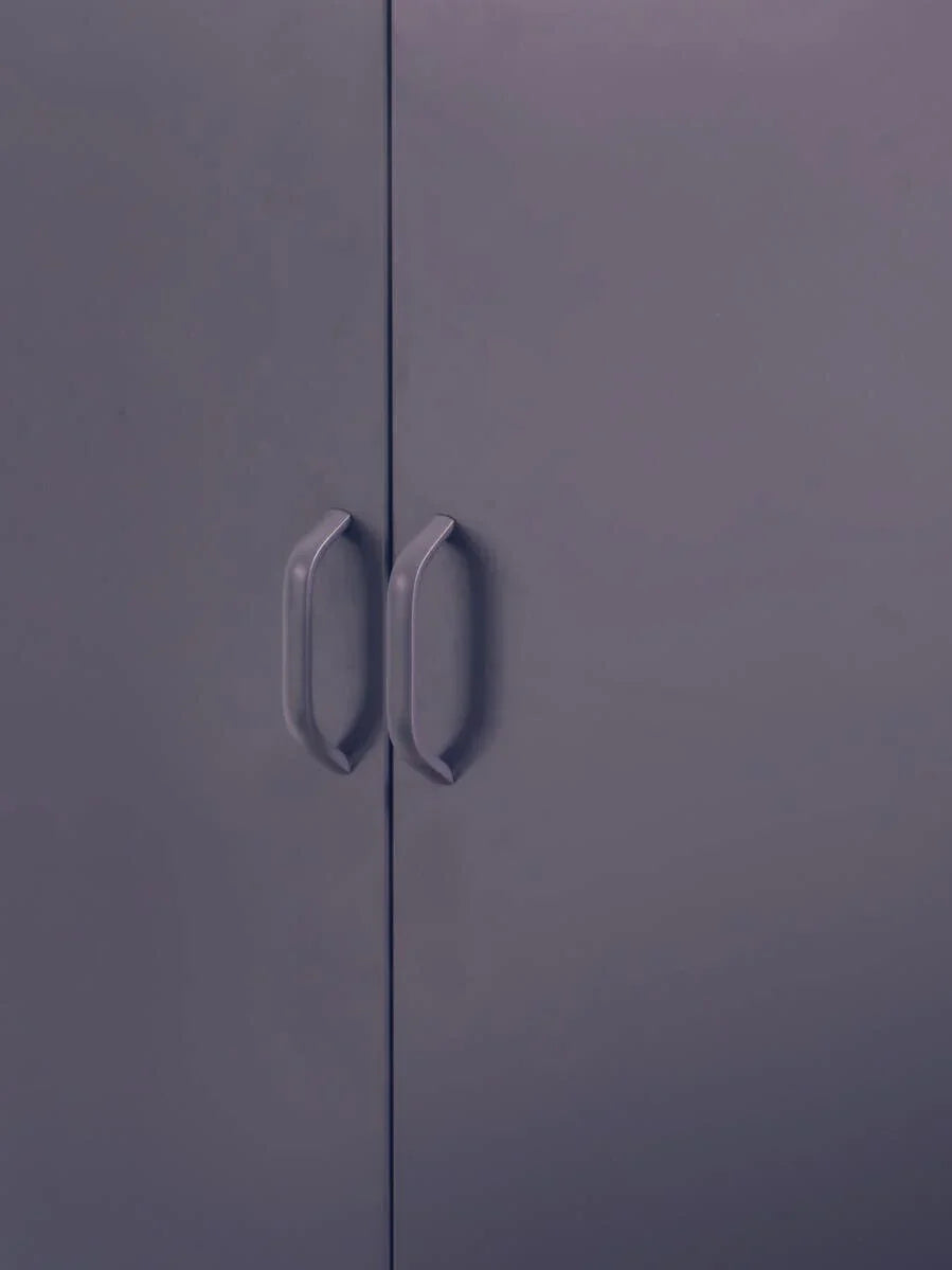 Closeup of grey wardrobe doors with vertical handles and smooth finish
