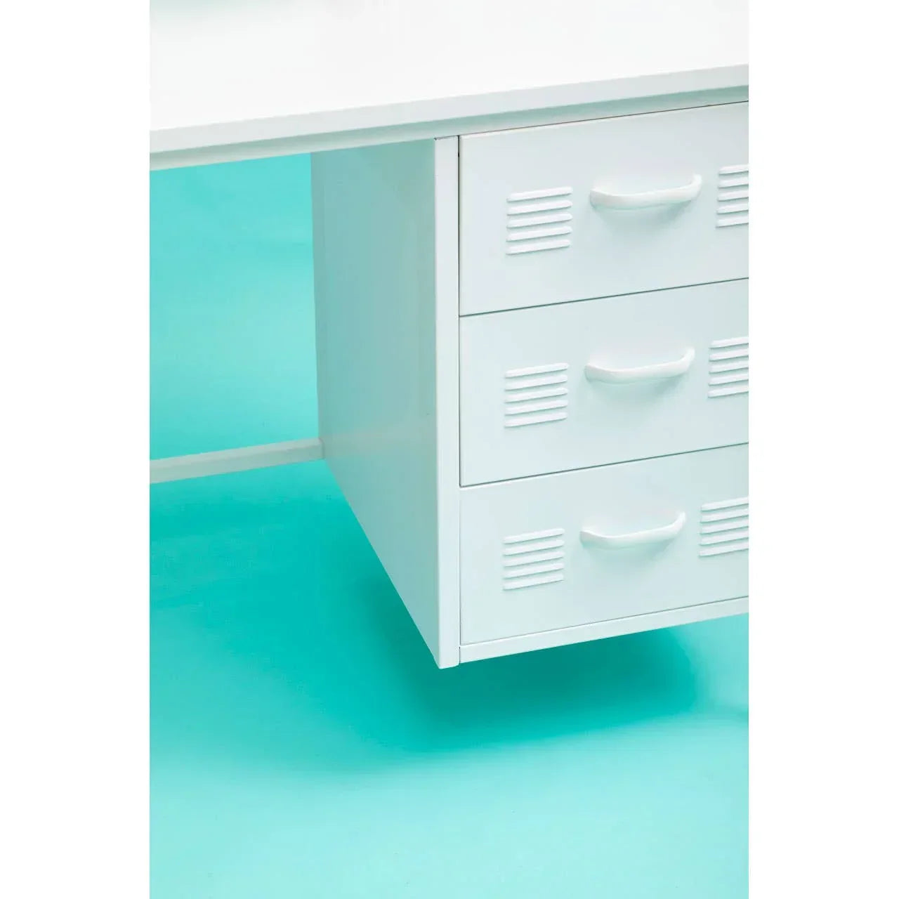 White metal desk with three storage drawers on a turquoise background