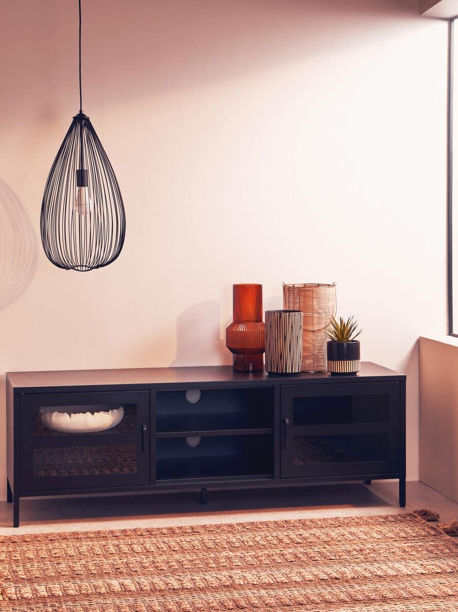 Black TV unit with glass doors, decorative vases, and a plant in a modern living room corner