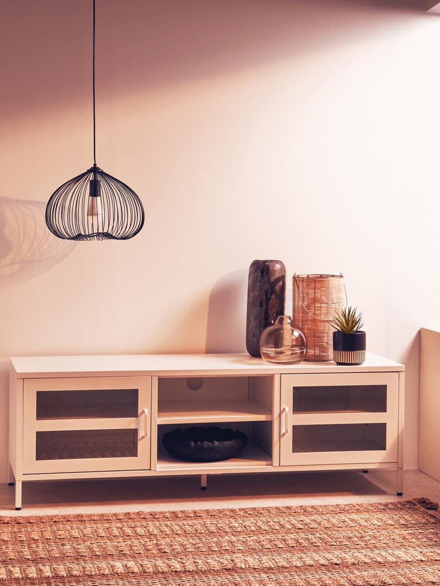 Modern cream TV unit with glass doors and open shelves, styled with vases and pendant light