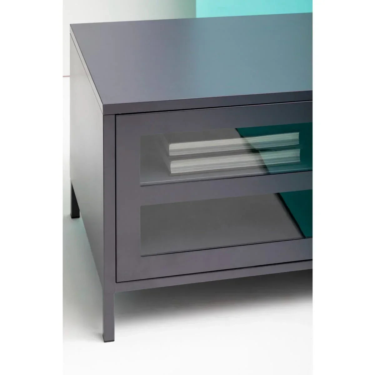 Grey coffee table with glass shelf and books, modern metal legs, close-up angle