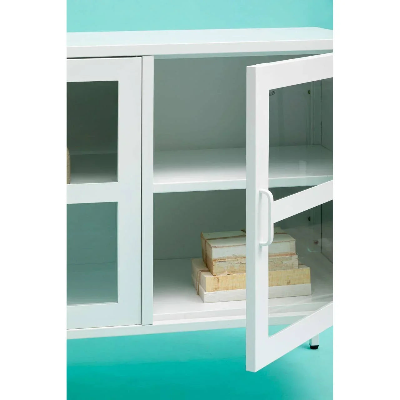 White storage cabinet with glass doors and shelves, shown open with stacked boxes inside