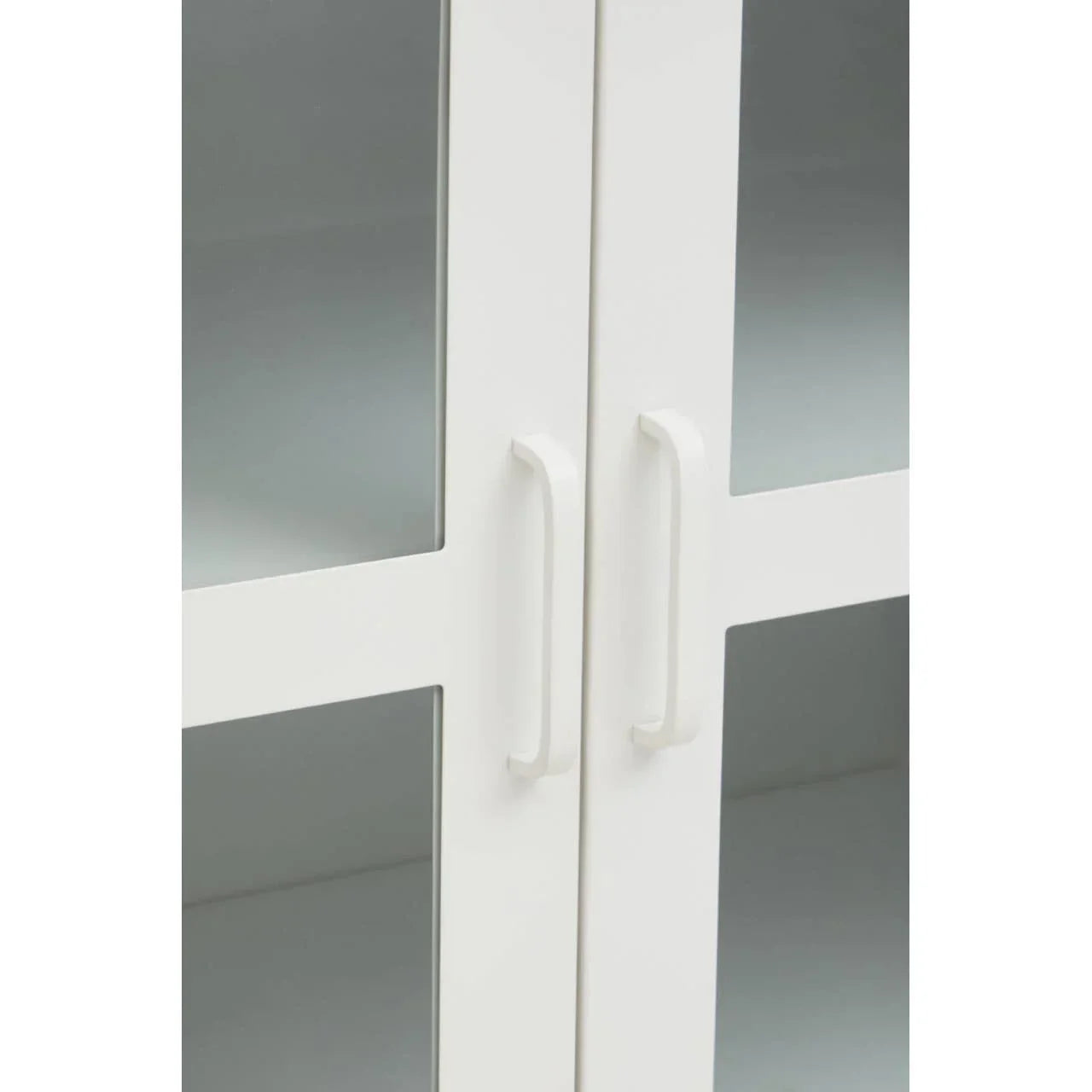 White cabinet doors with glass panels and modern handles close up
