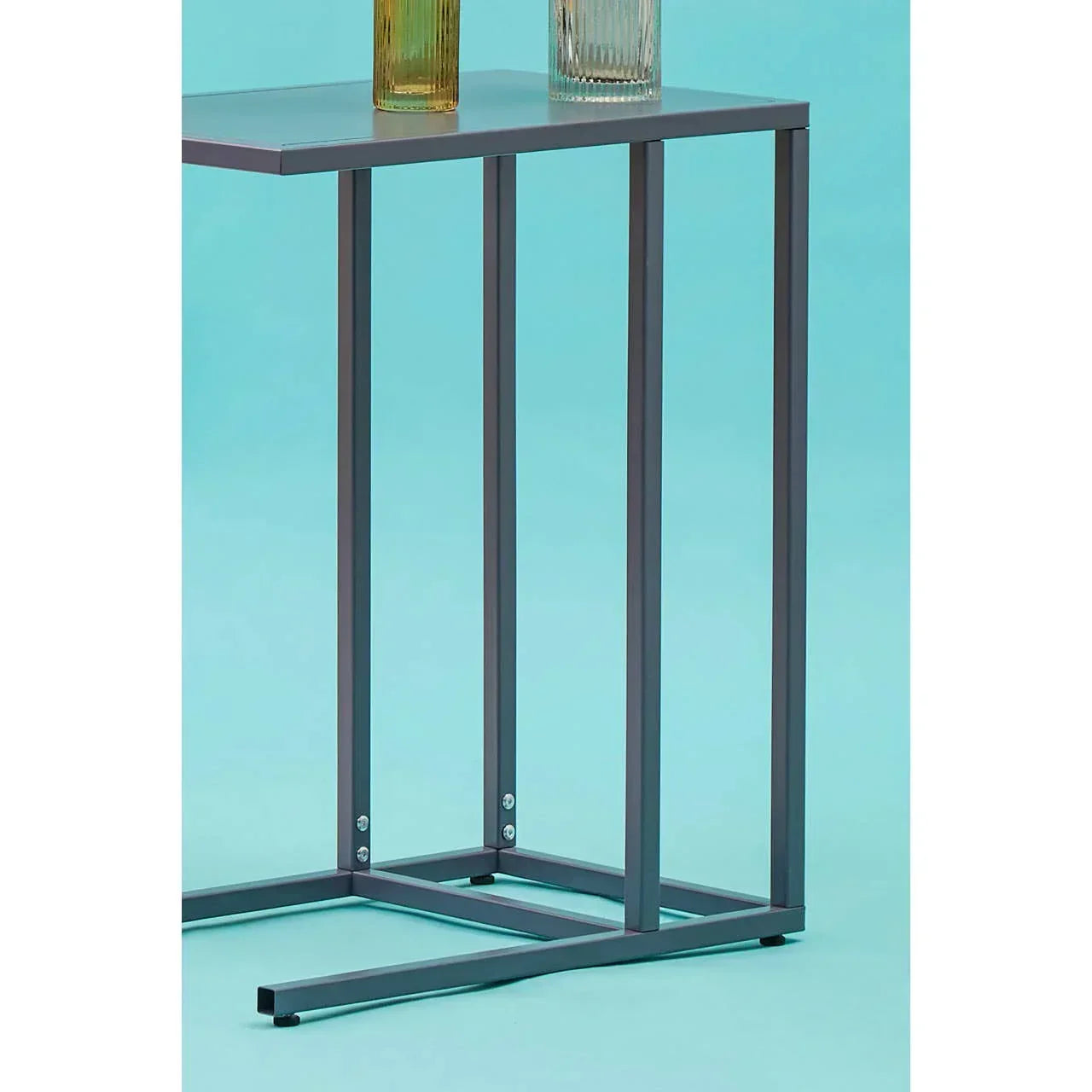 Metal side table with black frame and rectangular top, shown against a blue background