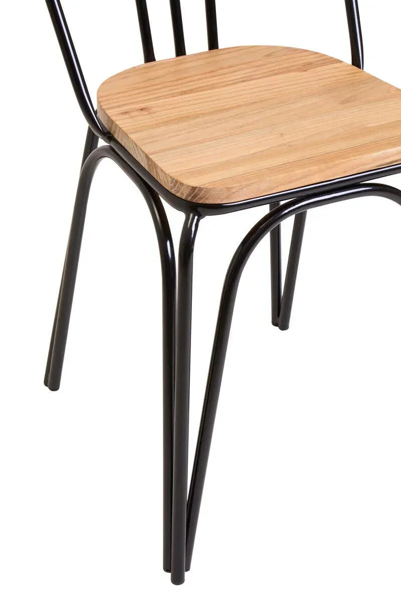 Dining chair with black metal legs and light wood seat close-up