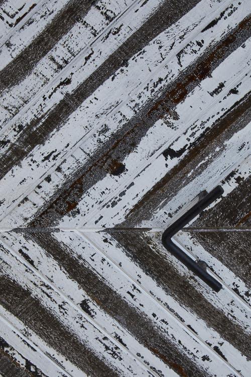 Allen wrench on distressed painted wooden surface with diagonal lines