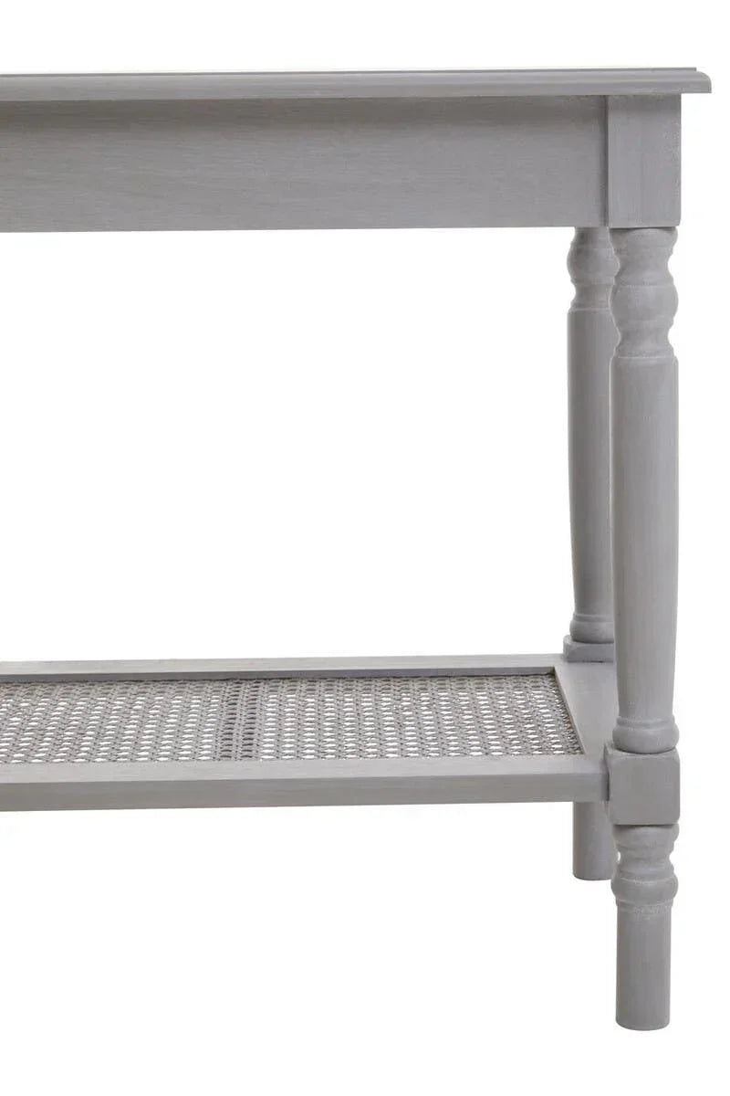 Grey wooden console table with turned legs and lower cane shelf, side angle view