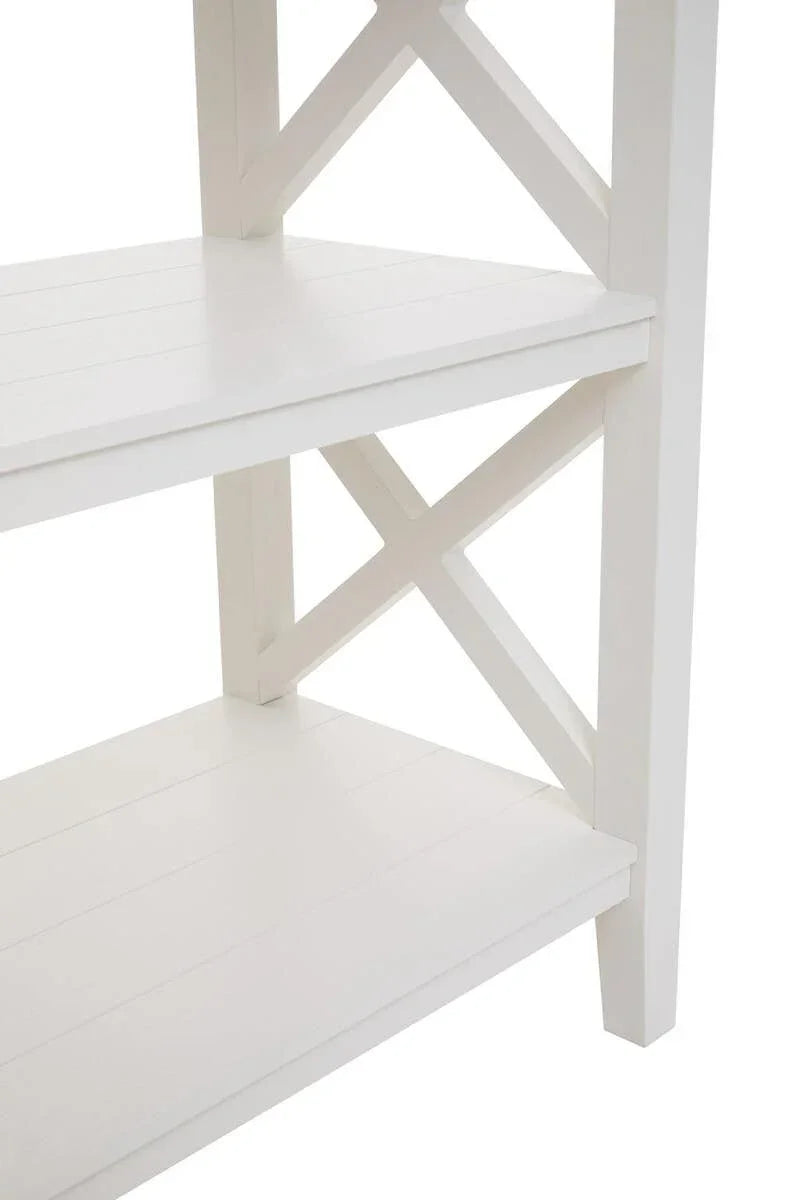 White wooden shelving unit with cross detail and slatted shelves, close side view