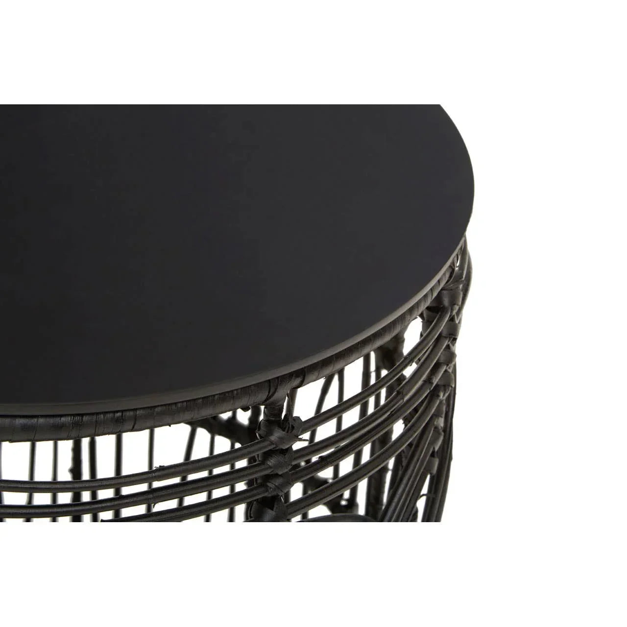 Round black rattan side table with smooth top and woven base, close-up view