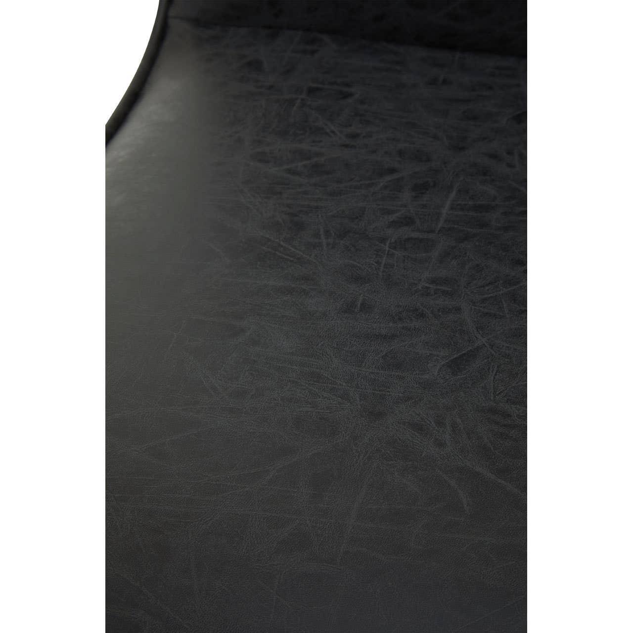 Close-up of black faux leather chair seat with textured finish