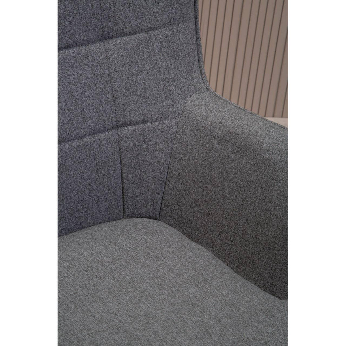 Close up of grey fabric armchair seat and backrest with subtle stitched detailing