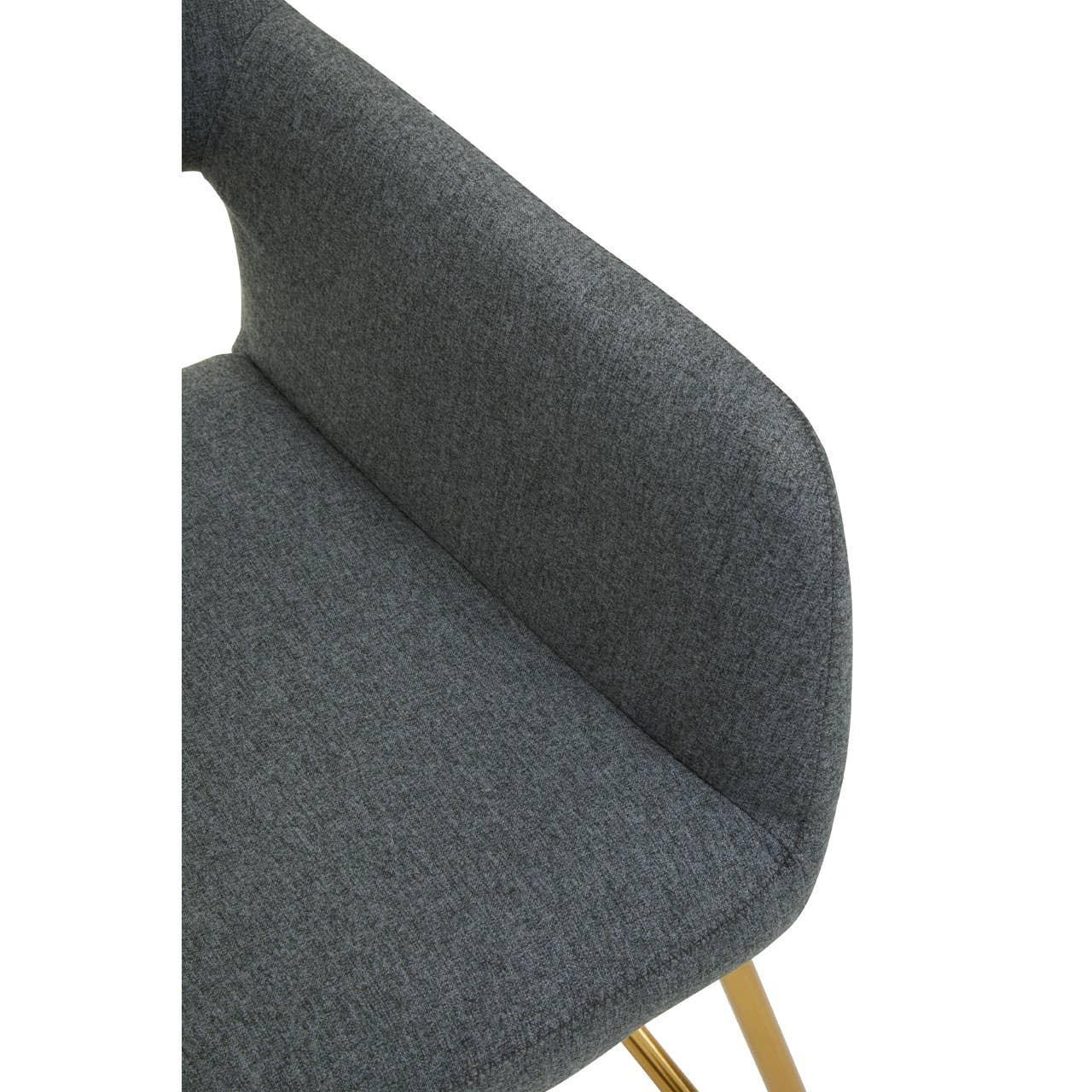 Dark grey upholstered dining chair with curved back and gold metal leg detail